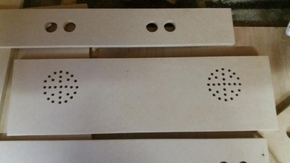 The holes drilled to allow the sound out